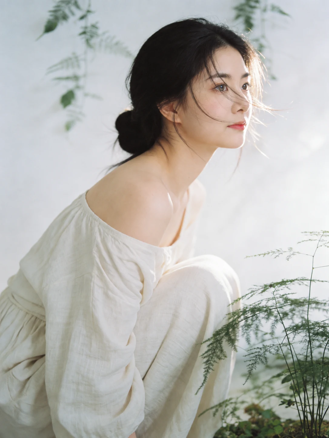 AI-assisted editorial portrait of Iris in a white dress beside delicate green foliage